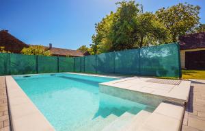 a swimming pool in a backyard with a fence at Stunning Home In Ivanska With Outdoor Swimming Pool in Ivanska