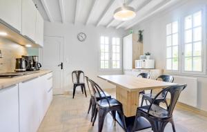 a kitchen with a wooden table and chairs at Pet Friendly Home In Omonville-La-Rogue in Omonville-la-Rogue