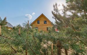 a house is seen through the trees at Stunning Home In Wustrow With Kitchen in Wustrow