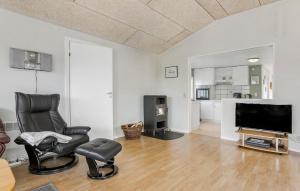 a living room with two chairs and a flat screen tv at Beautiful Home In Middelfart With Wifi in Middelfart
