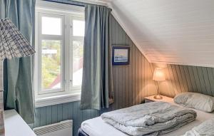 a bedroom with two beds and a window at Amazing Home In Skjrhalden With Kitchen in Skjærhollen