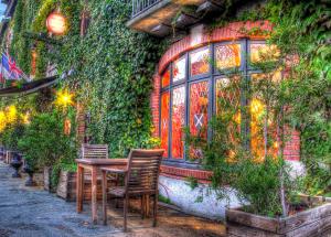 a table and chairs in front of a building at Cit'Hotel Marie Stuart in La Roche-sur-Yon