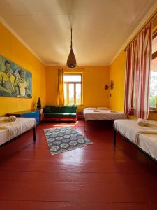 a room with three beds and a couch in it at Karma Hostel in Martvili