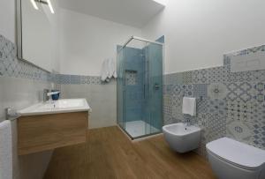 a bathroom with a shower and a toilet and a sink at I Tre Golfi - Covo dei Pirati in San Vito lo Capo
