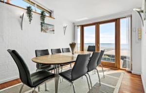 a dining room with a table and chairs at 3 Bedroom Cozy Home In Eg in Egå