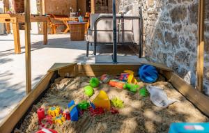 a sandbox with toys in the sand in a room at Nice Home In Zemunik Donji With Kitchen in Smrdelje