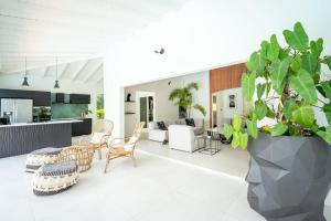 a living room with a couch and a table at Villa 0.5 in Saint-François
