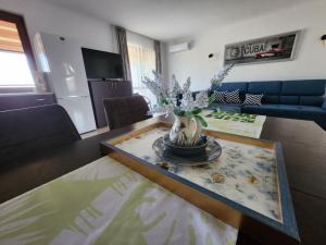 a living room with a table with a vase of flowers on it at Famagusta Antoniya in Aheloy