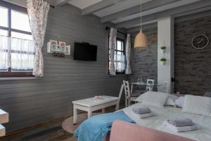 a living room with a couch and a table at Apartmani Ivanka in Rakovica