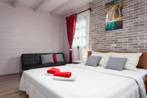 two beds in a room with red towels on them at Apartmani Ivanka in Rakovica +11 photos
