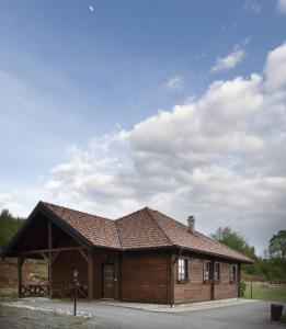 a small wooden building with a roof at Apartmani Ivanka in Rakovica