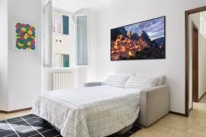 a bedroom with a bed with a picture on the wall at Casa Dolce Casa - Centro Storico in Como