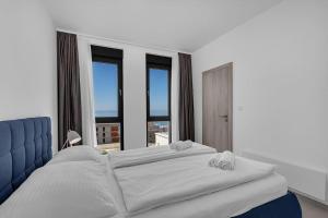 a bedroom with a large bed and large windows at Ferienhaus Komplex - Villa Oliver - Makarska Exklusiv in Veliko Brdo +19 photos