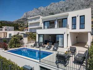 a villa with a swimming pool and a house at Ferienhaus Komplex - Villa Oliver - Makarska Exklusiv in Veliko Brdo
