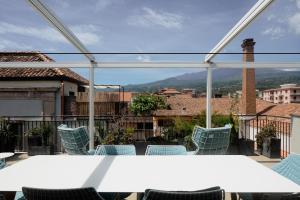 a table and chairs on a balcony with a view at Casa Rebecca in Riposto