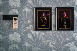 duas imagens emolduradas de um homem numa parede em Krisotel em Amesterdão