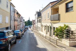 a street with cars parked on the sides of buildings at New Premium Apartment Rivetta in Poreč