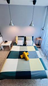 a large bed in a room with two pillows on it at Les Appartements De Lina - West city 2 - Self Check-In - in La Grande Motte