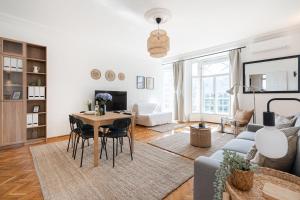 a living room with a table and chairs at NEO Rooftop Home with AC in Budapest