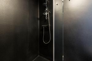 a shower in a bathroom with a glass door at Casa da Muralha in Porto