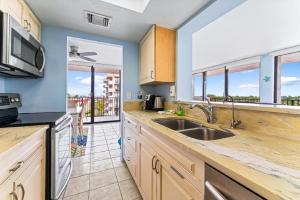 a kitchen with a sink and a counter top at Our House at the Beach 502E By Beachside Management in Siesta Key