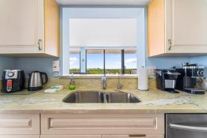 a kitchen counter with a sink and a window at Our House at the Beach 502E By Beachside Management in Siesta Key