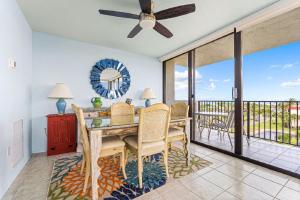 a dining room with a table and a balcony at Our House at the Beach 502E By Beachside Management in Siesta Key