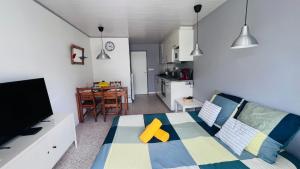 a bedroom with a bed with a yellow star on it at Les Appartements De Lina - West city 2 - Self Check-In - in La Grande Motte