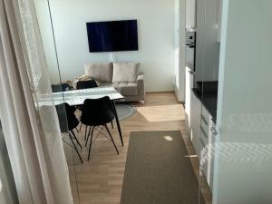 a living room with a table and chairs and a couch at Topaasi in Tampere +1 photo
