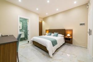 a bedroom with a large bed and a bathroom at Station House 45 in Naples
