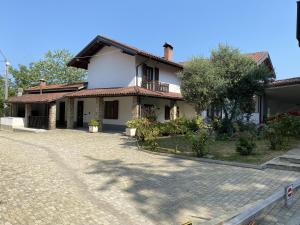 a house with a driveway in front of it at Case Vista Alta Langa, Studio Belbo in Cravanzana +10 photos