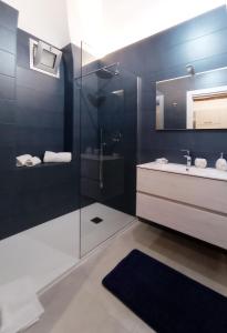 a bathroom with a shower and a sink and a mirror at La perla casa vacanze in Barletta