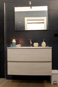 a bathroom with a sink and a mirror at La perla casa vacanze in Barletta