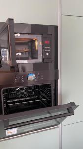 a microwave oven with its door open in a kitchen at SUNNY HILL Apartament Pristina Kosovo in Pristina