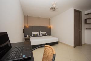 Voodi või voodid majutusasutuse Hotel Perlatto toas