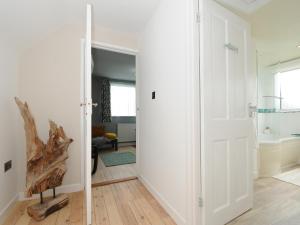 a hallway with a white door in a room at Sea Drift in St Austell +44 photos