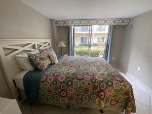 a bedroom with a large bed with a window at Palm Bay Club in Siesta Key