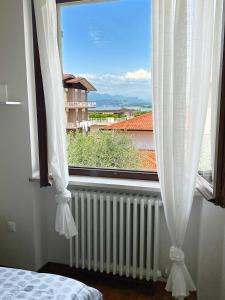 una camera da letto con una grande finestra con termosifone di Villa 70 a Peschiera del Garda