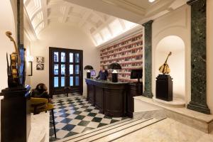 a bar in a room with a checkered floor at Mascagni Luxury Rooms & Suites in Rome