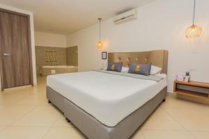 Voodi või voodid majutusasutuse Hotel Perlatto toas