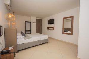 Voodi või voodid majutusasutuse Hotel Perlatto toas