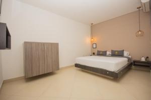Voodi või voodid majutusasutuse Hotel Perlatto toas