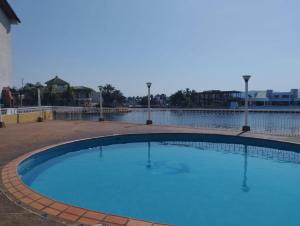 a large swimming pool with blue water at Villa Martinica in El Morro de Barcelona