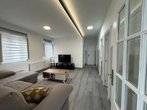 a living room with a couch and a tv at Casa A Gateira in O Casal Pontevedra