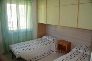 two twin beds in a room with a window at Appartamento Casa Anna in Garda +35 photos