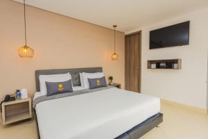 Voodi või voodid majutusasutuse Hotel Perlatto toas