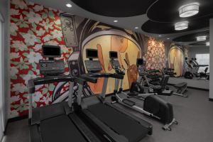 a gym with cardio equipment and a wall with flowers at SpringHill Suites Houston Intercontinental Airport in Houston