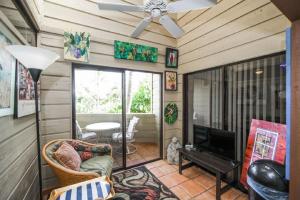 a living room with a ceiling fan and a television at Fanta-Sea 47 By Beachside Management in Siesta Key +52 photos