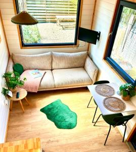 a living room with a couch and a table at Tiny house with garden and jacuzzi near Amsterdam in Vijfhuizen