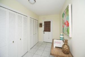 a hallway with white closet doors and a table at Living the Dream in Siesta Key